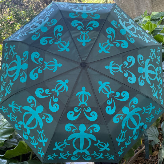 Decorative umbrella with blue patterns on a green leafy background
