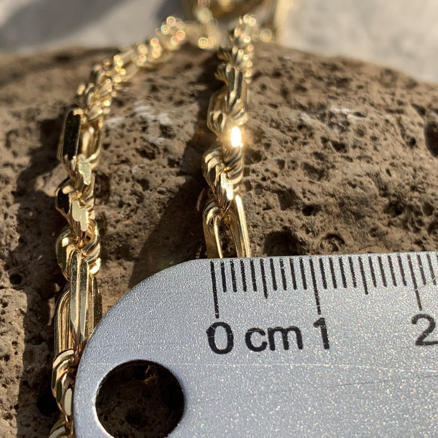24" Inch Milano chain with Hawaiian Scroll Fish hook. Size of chain near ruller.