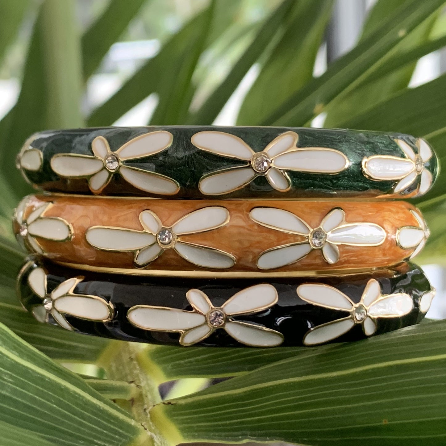 Plumeria Bracelet with Cubic Zirconia showing green, gold and black colors.