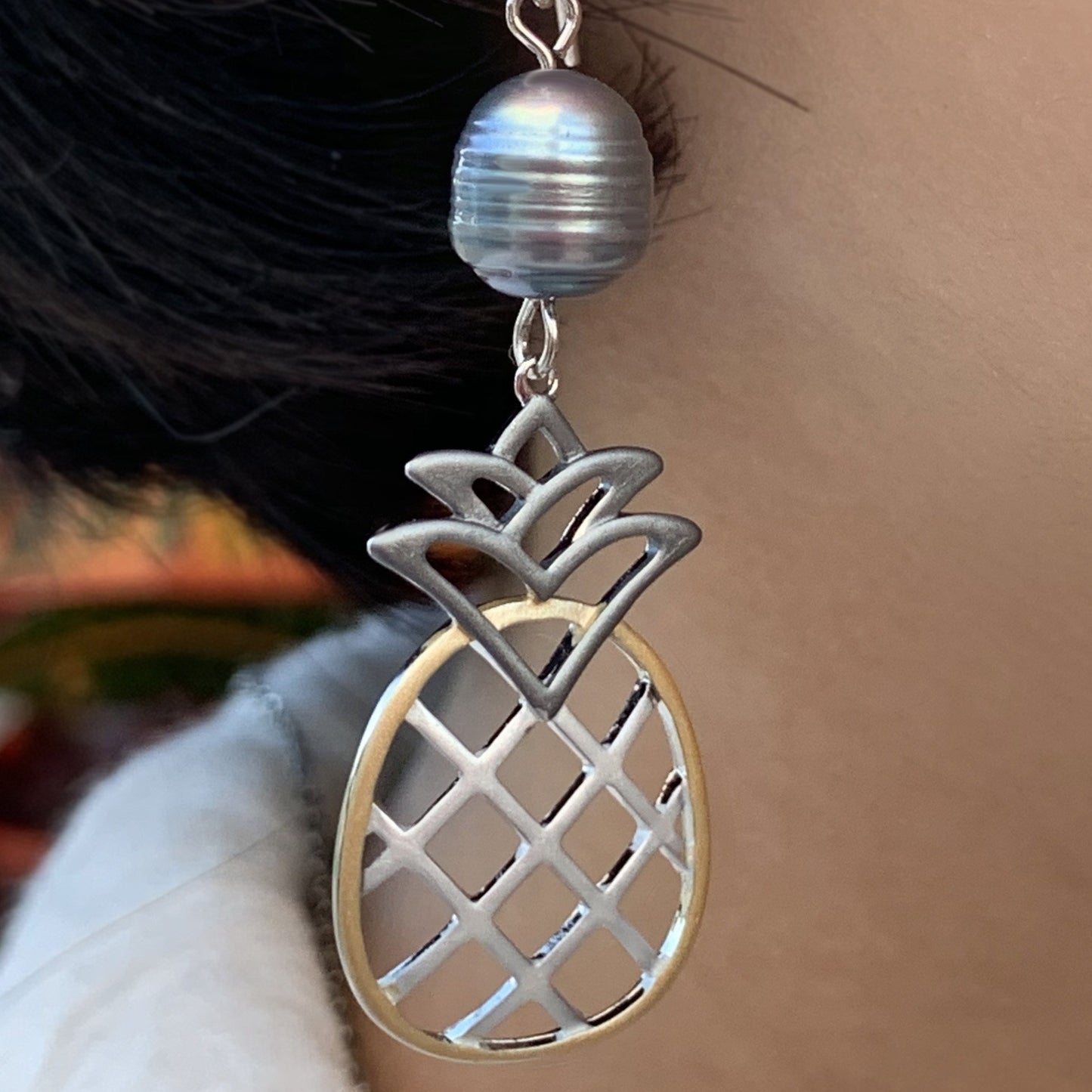 Close up of Pineapple Pearl Tricolor earring with black pearl.