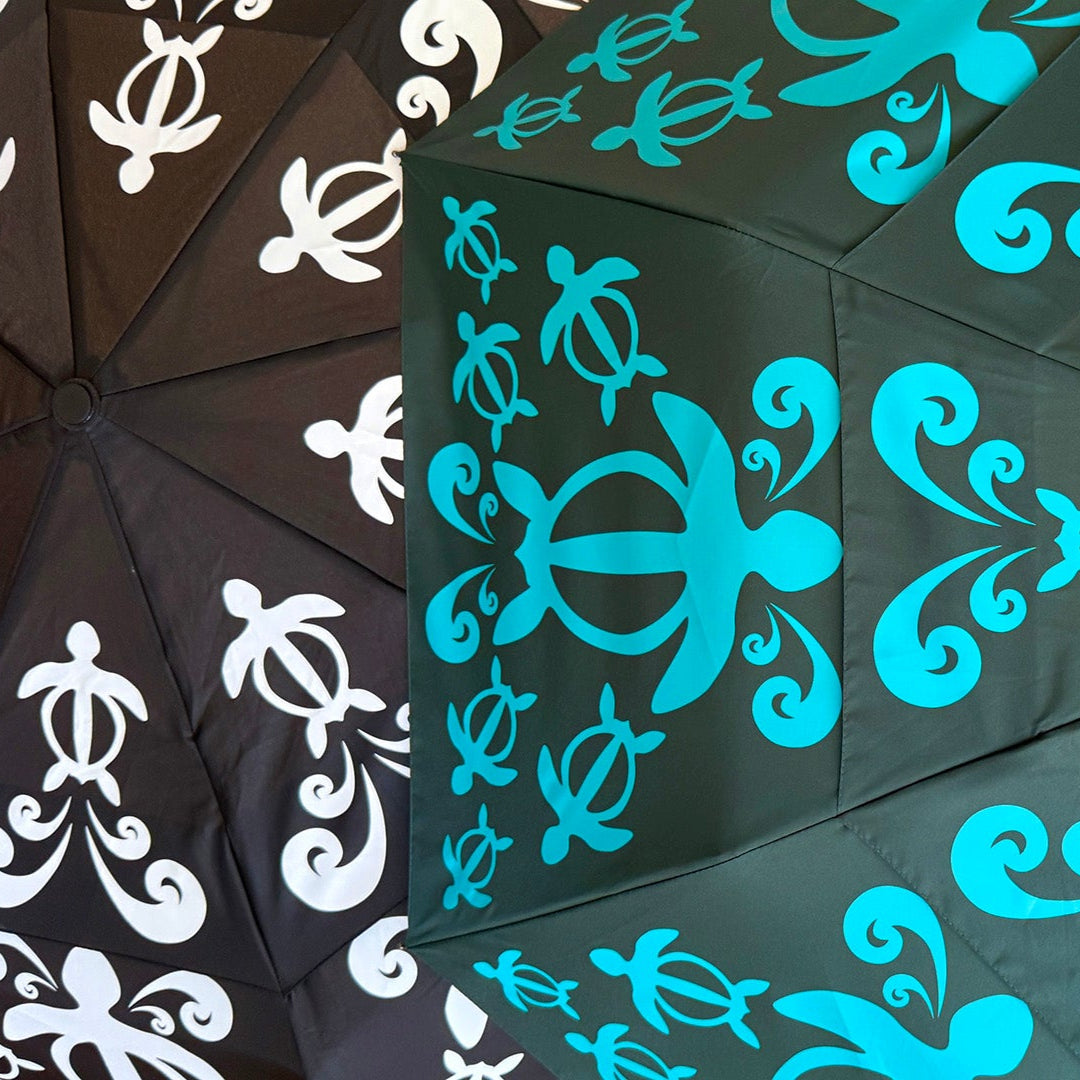 Umbrella with honu patterns on a dark background