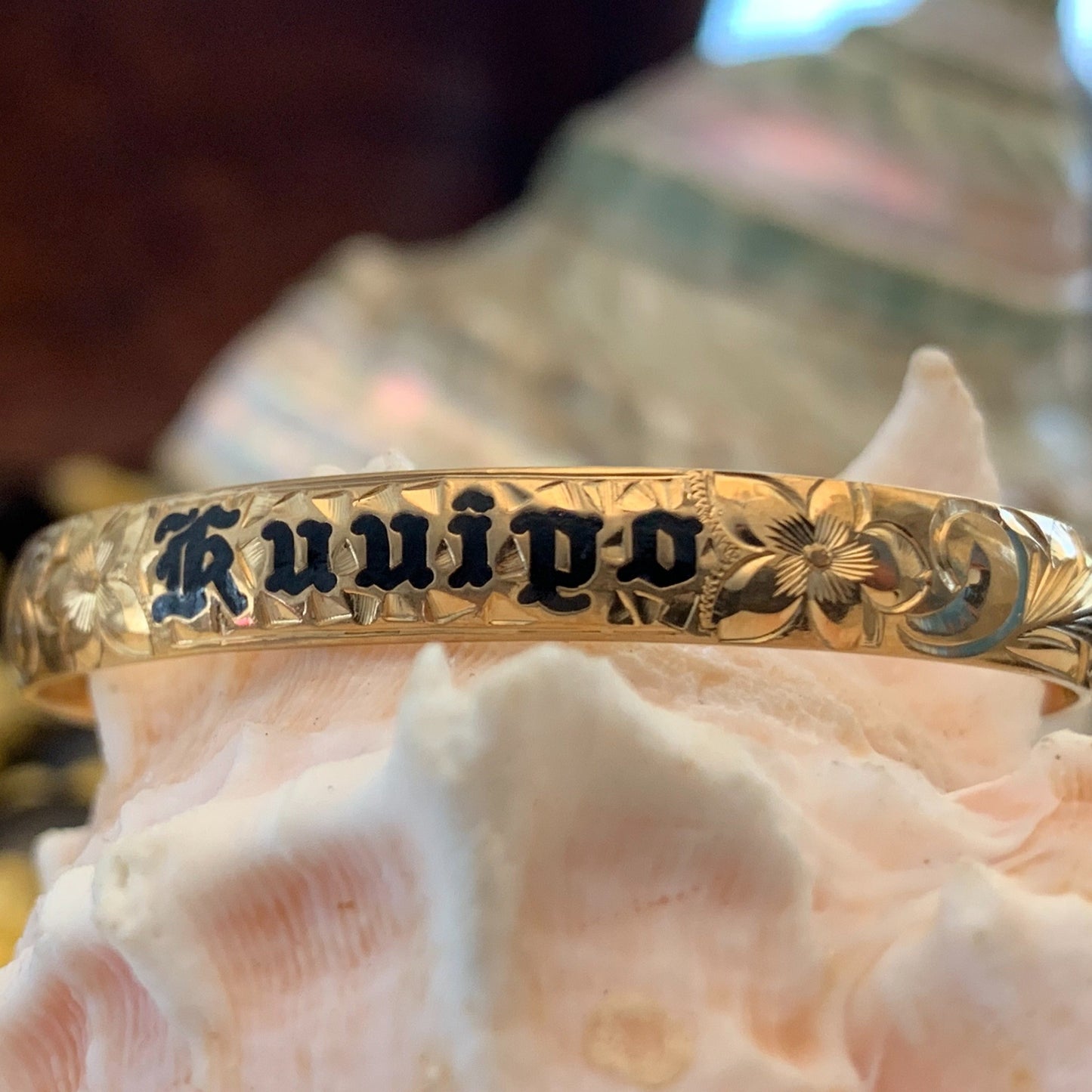 Baby Hawaiian heirloom bracelet with straight edge and black lettering.