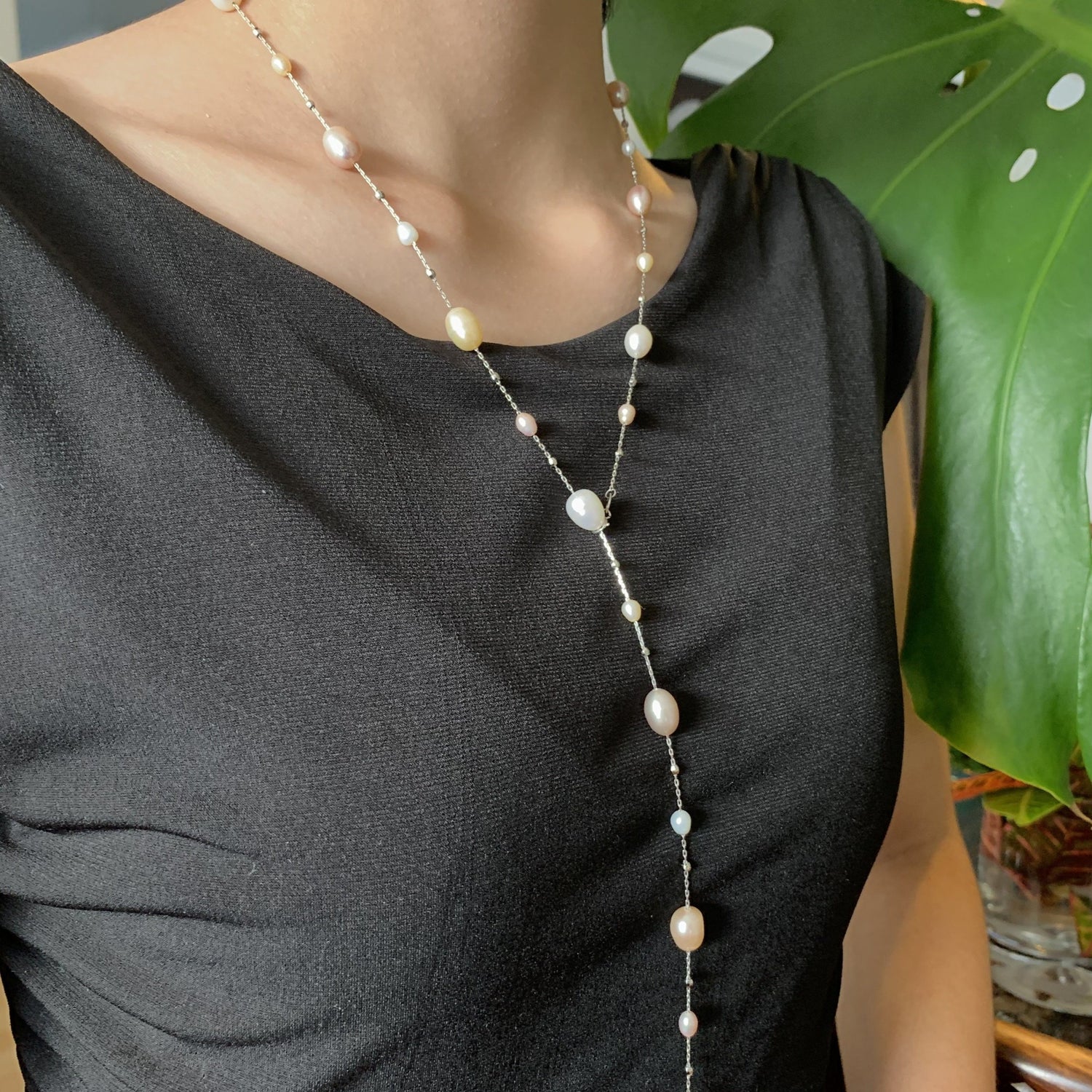Dew drop freshwater pearl necklace with 36" chain length on model.