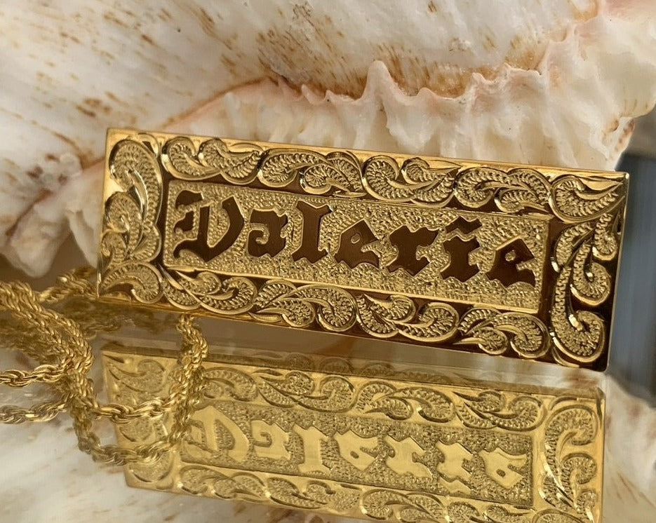 Nameplate with straight edge and raised gold lettering.