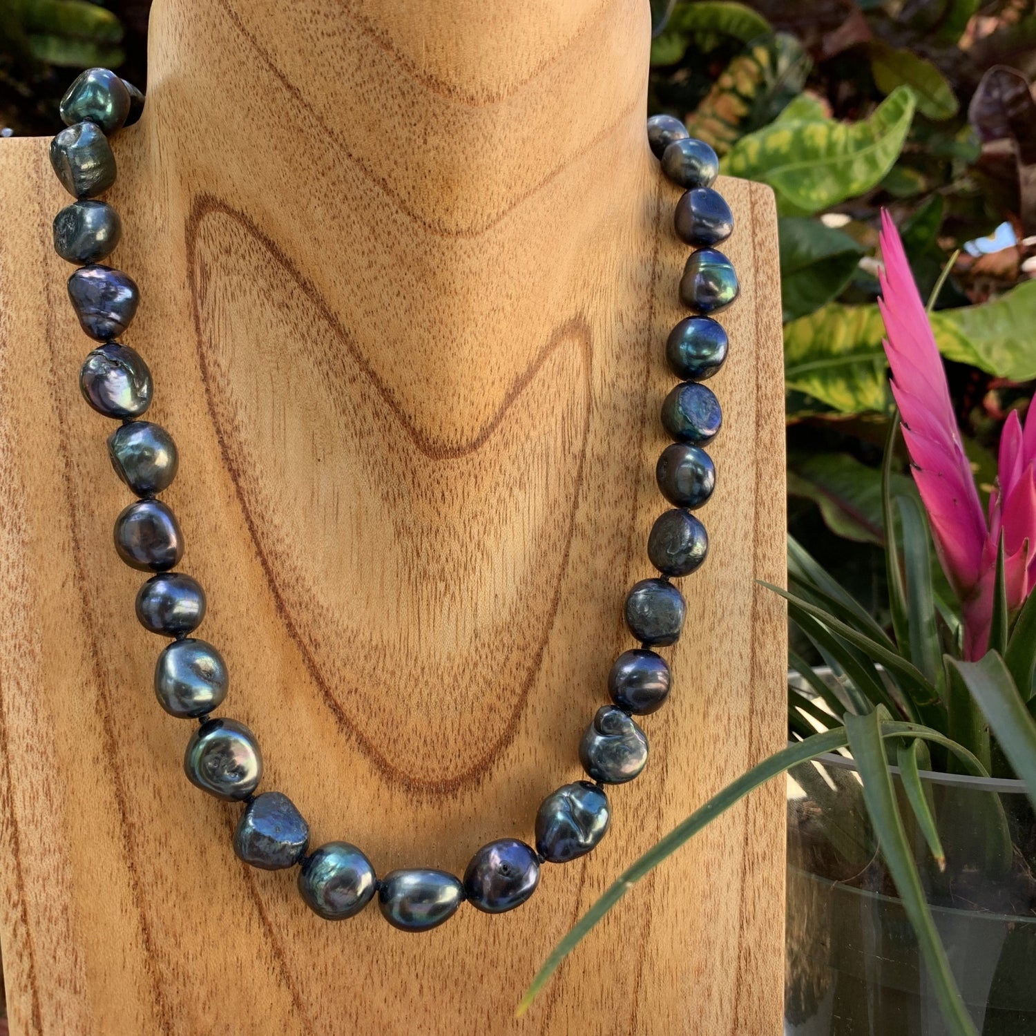 Baroque pearl necklace on display shown in black.
