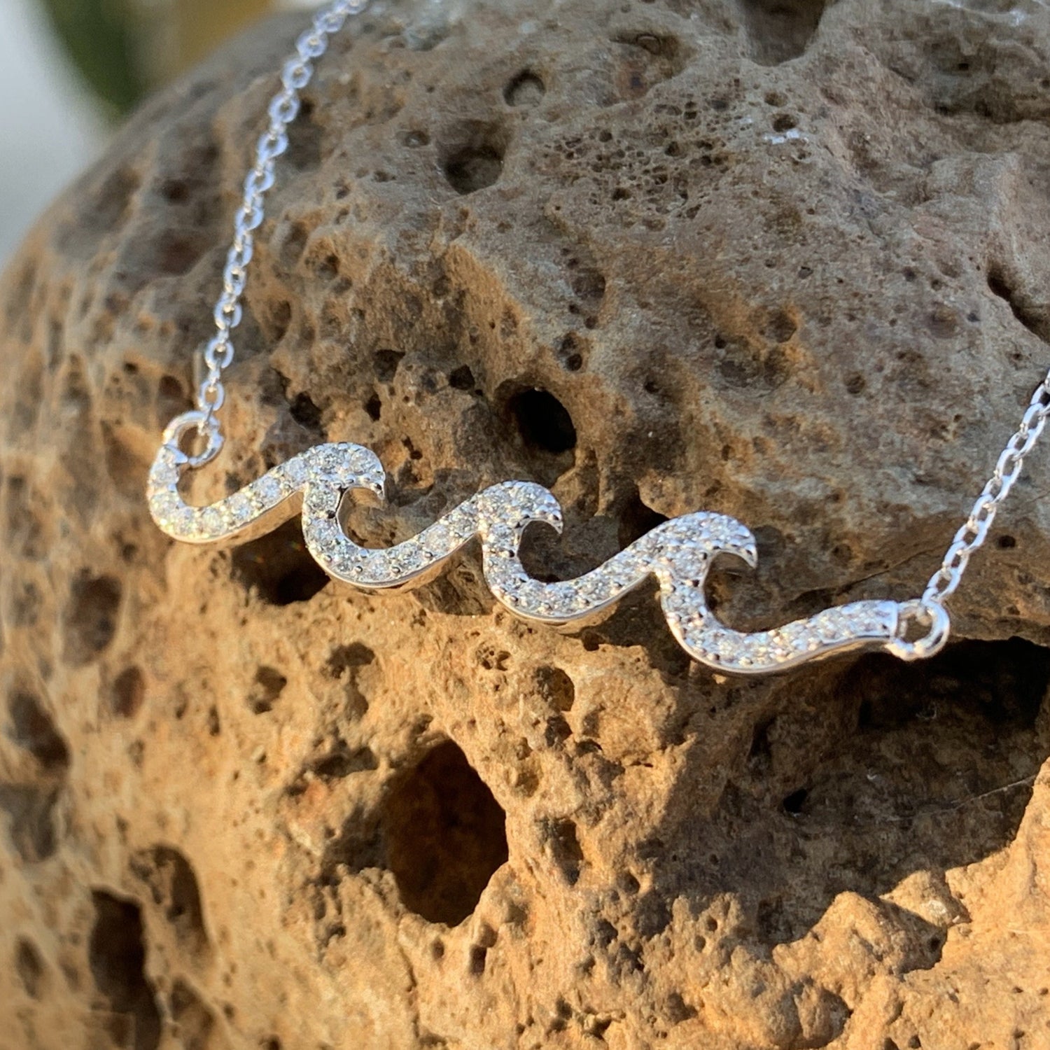 Crystal wave pave pendant in white caps.
