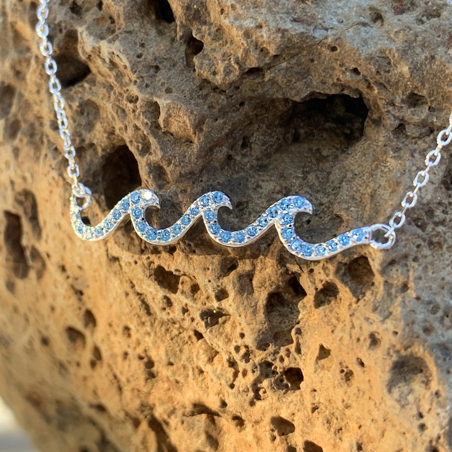 Crystal wave pendant in ocean blue.