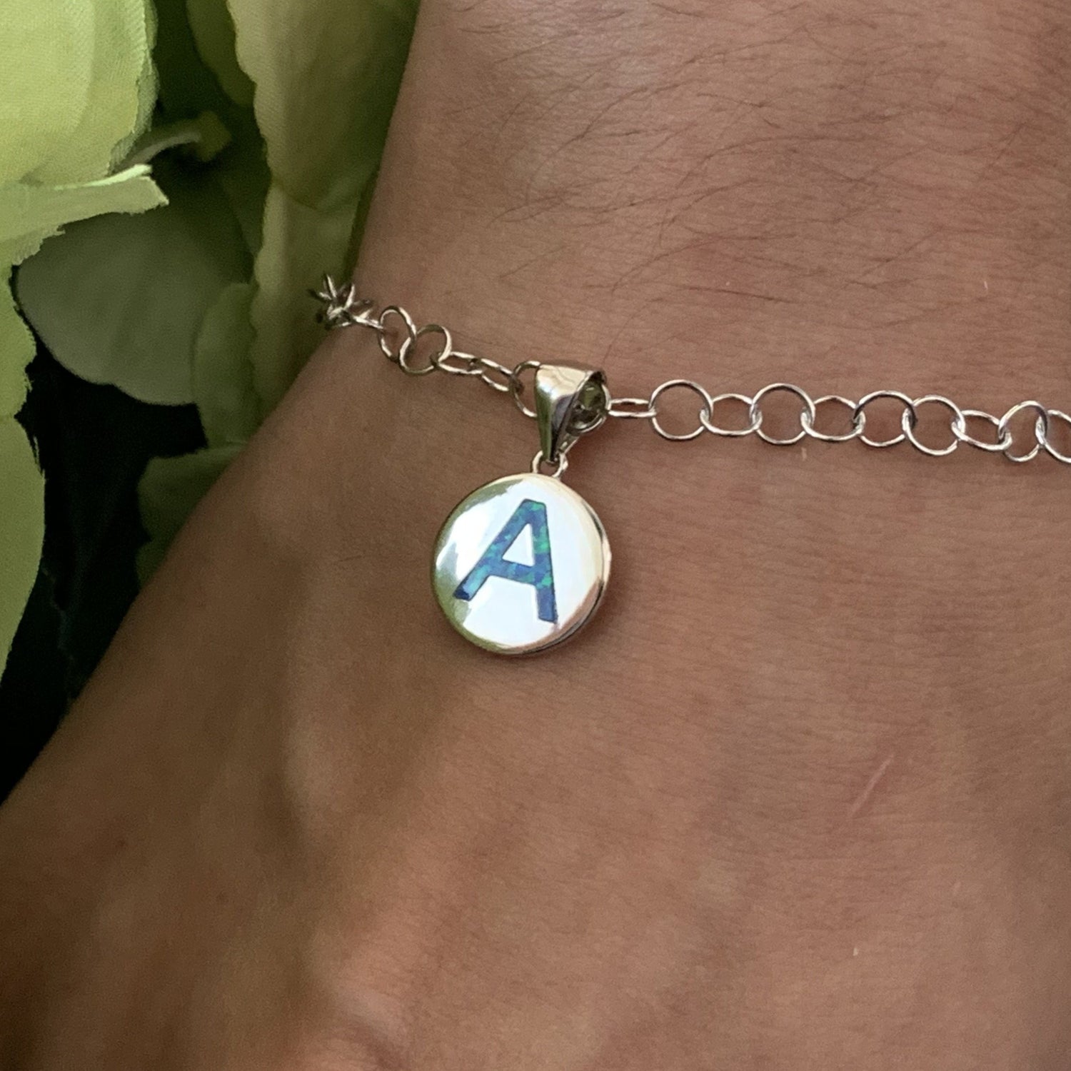 Opalite initial charm shown on model as a charm bracelet.