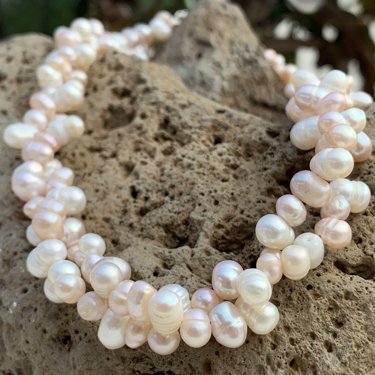 Cluster pearl necklace in solid whites and light pink pearls.