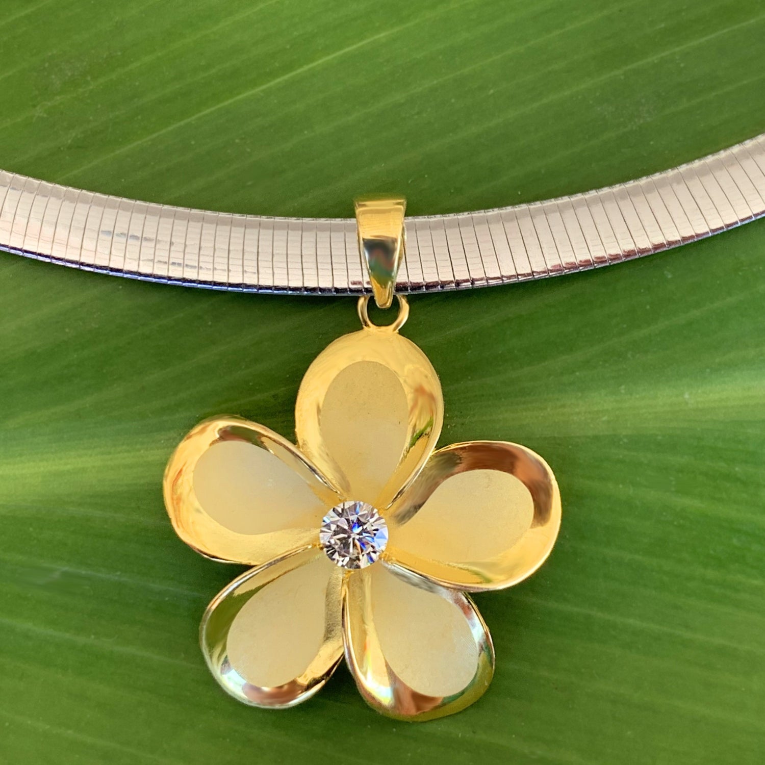 Close up of Omega Chain & Plumeria Pendant with the reverse silver side of Omega chain showing how you can wear it with the gold or silver side showing.