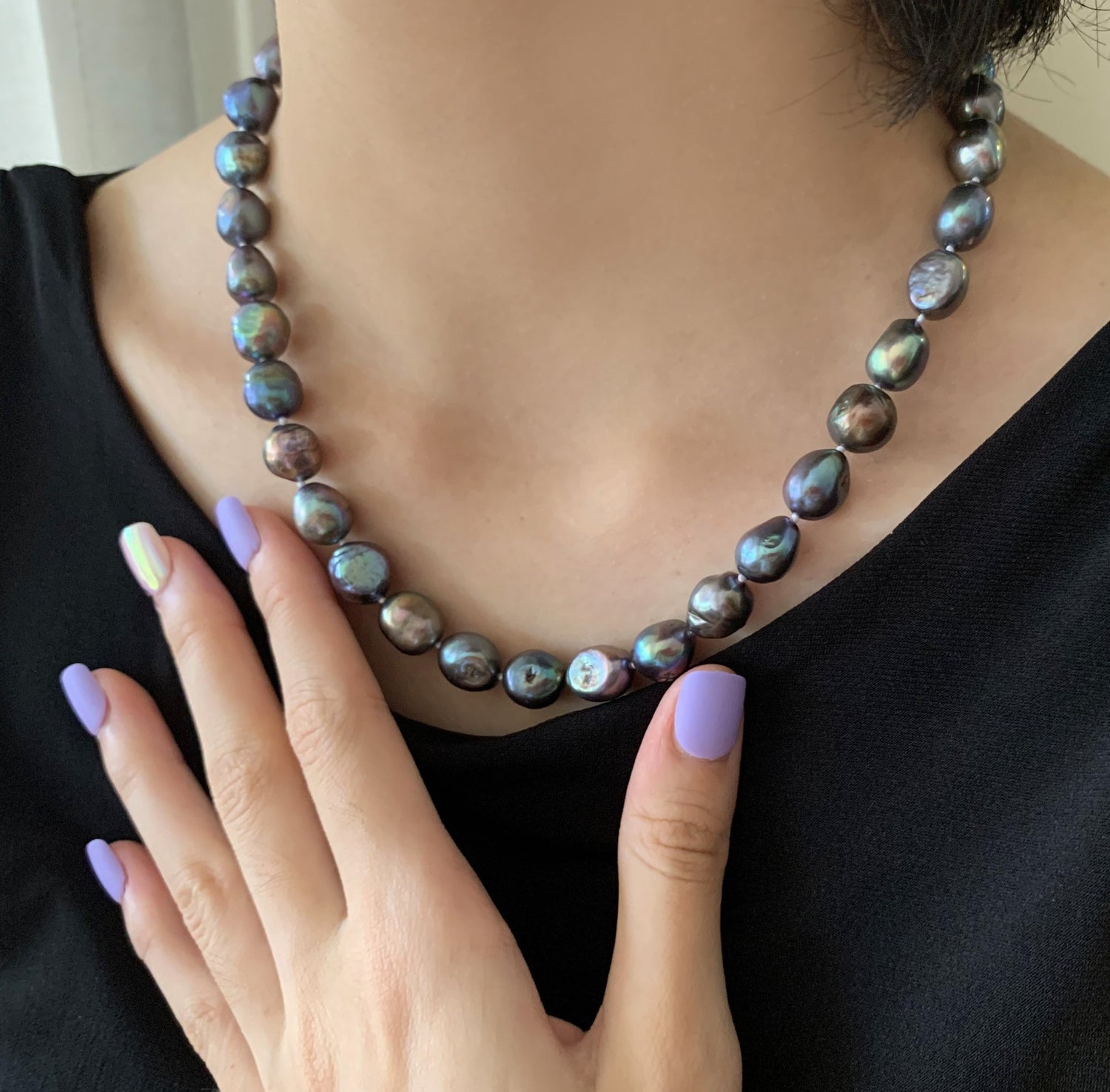Black 10mm Baroque stand pearls on model.