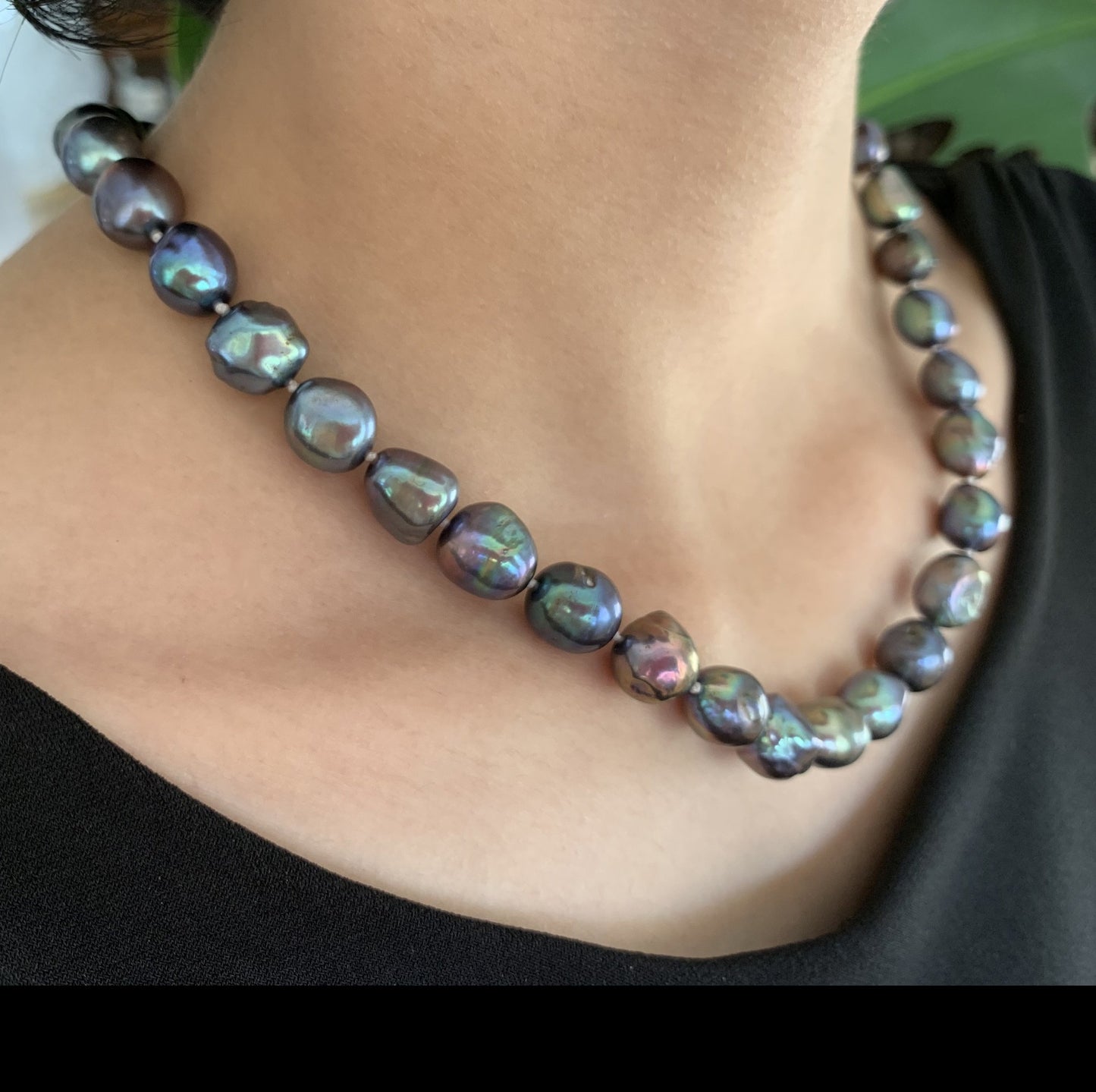 Baroque pearl necklace shown in black on model.