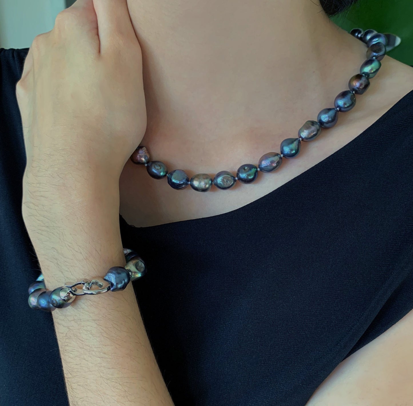 Baroque pearl necklaces shown in black on model along with bracelet.