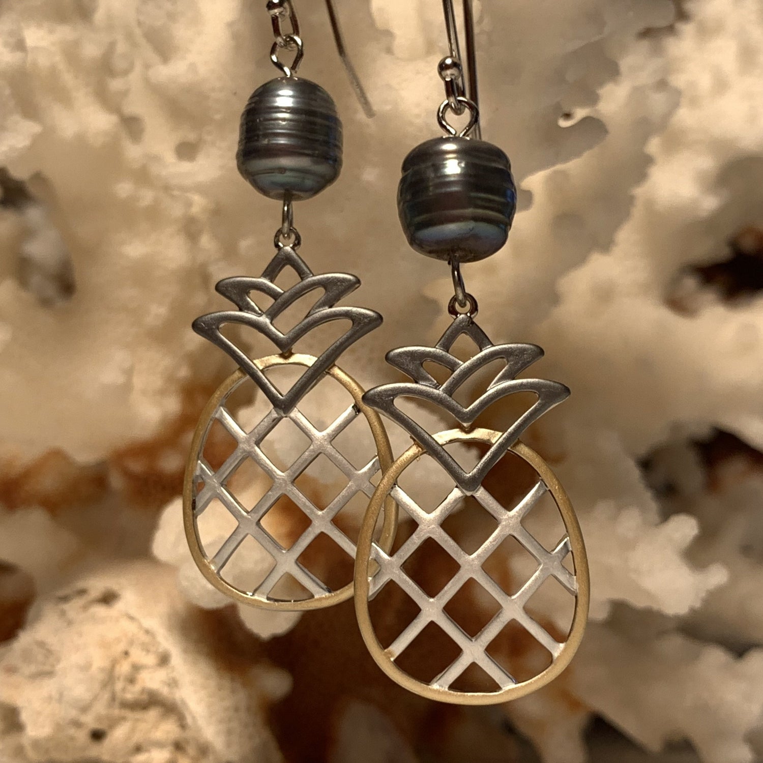Close up of black tri color earrings together side by side.