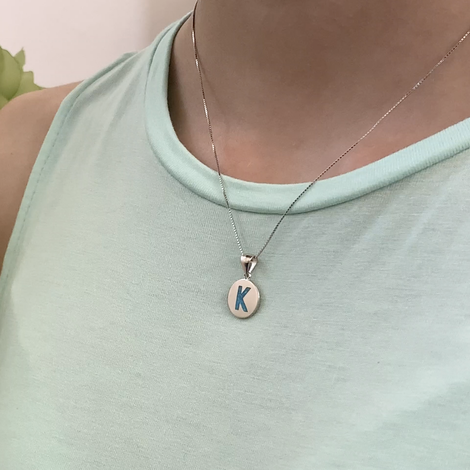 Opalite charm shown on model as a necklace.