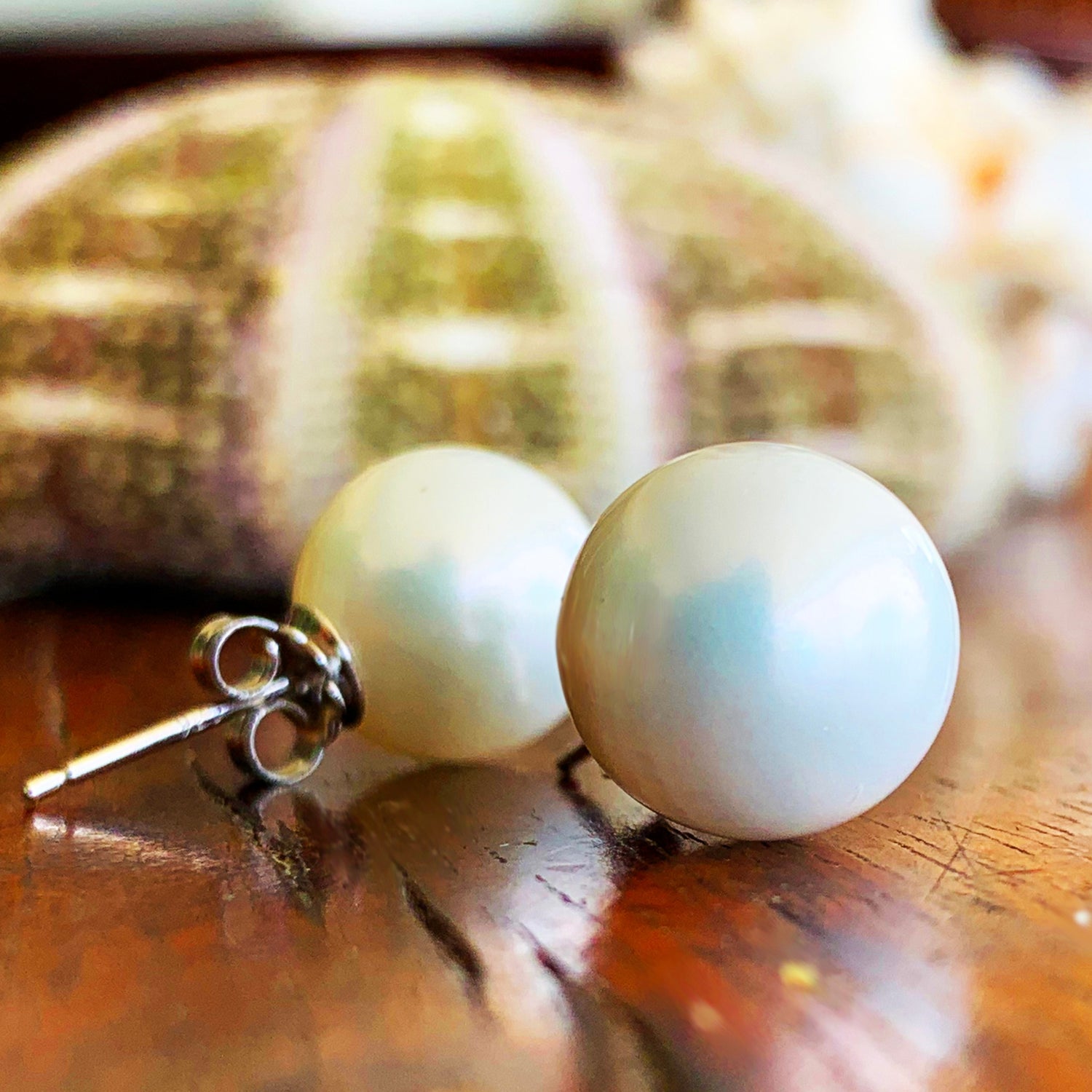 White 12mm shell pearls with sterling silver posts.